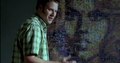 Seth Rogen in front of Barbarella mosaic poster.
Still frame from 